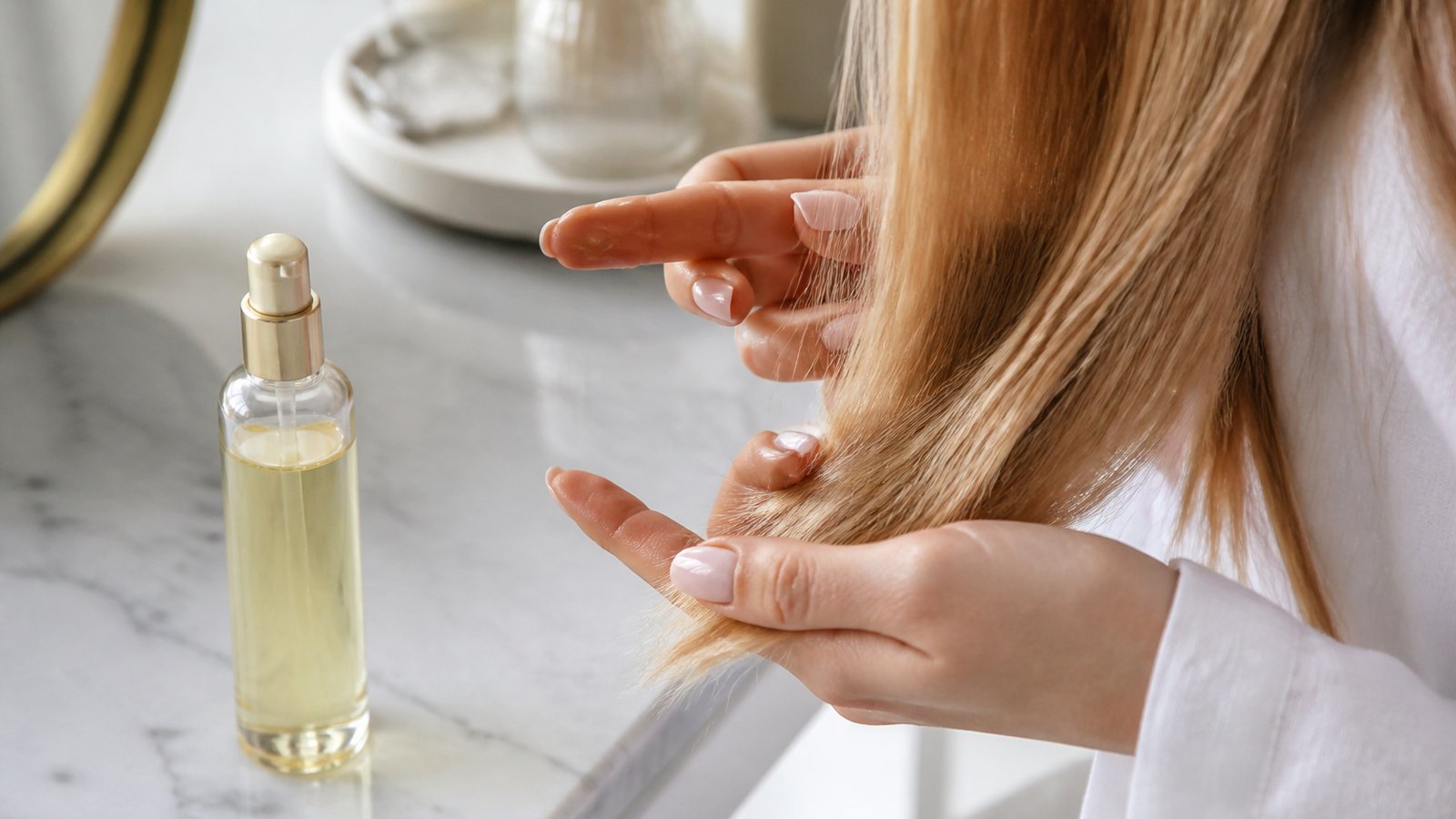 Tiny serum amount on fingertips for fine hair ends